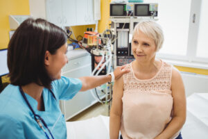 Female doctor consoling patient | Featured image for cosmetic surgery support blog.