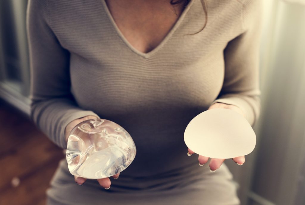 Woman holding two breast implants | Featured image for Motiva Implants: Addressing Real Concerns blog Brisbane Cosmetic Clinic